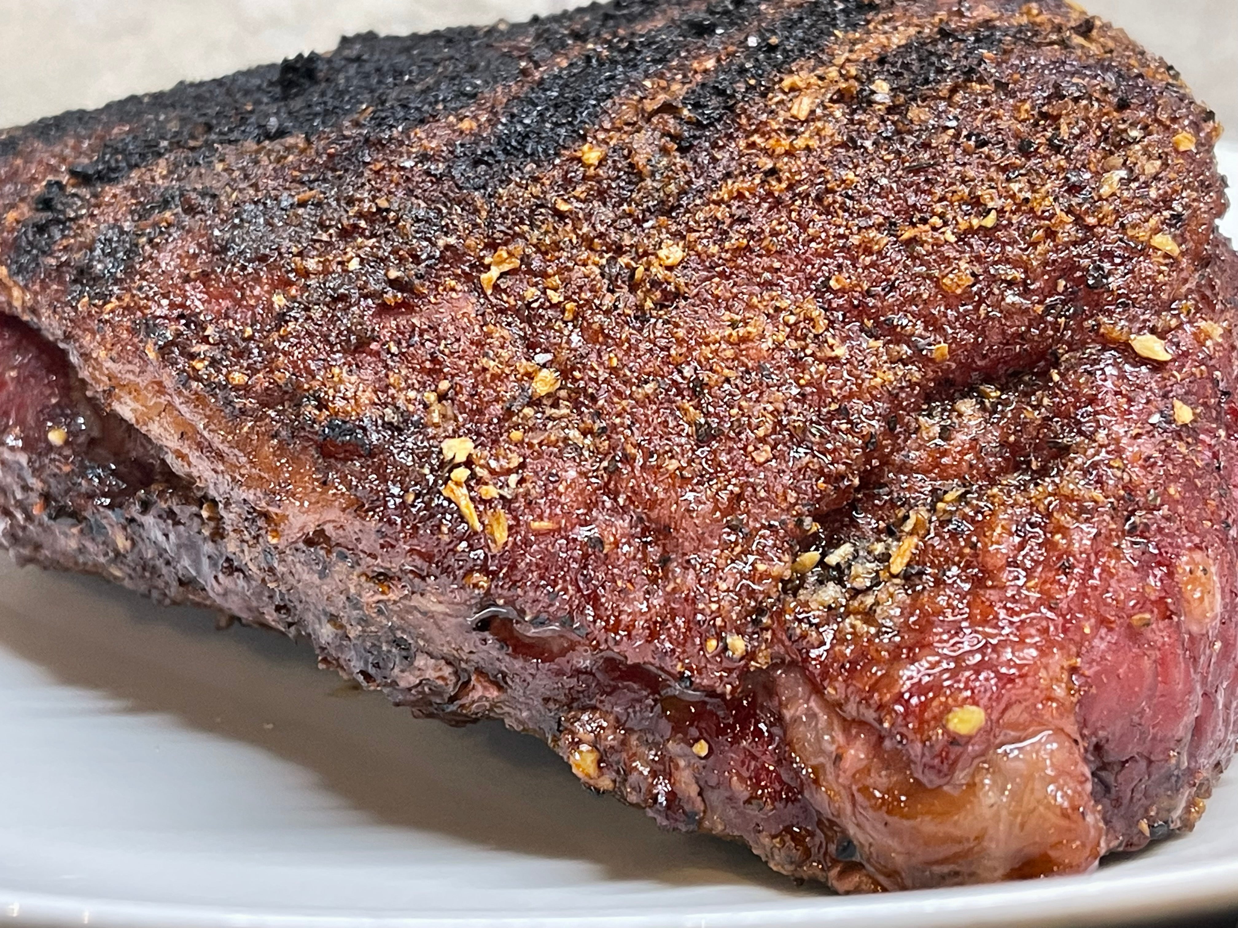 Picture of a picanha steak, golden brown with grill marks on top