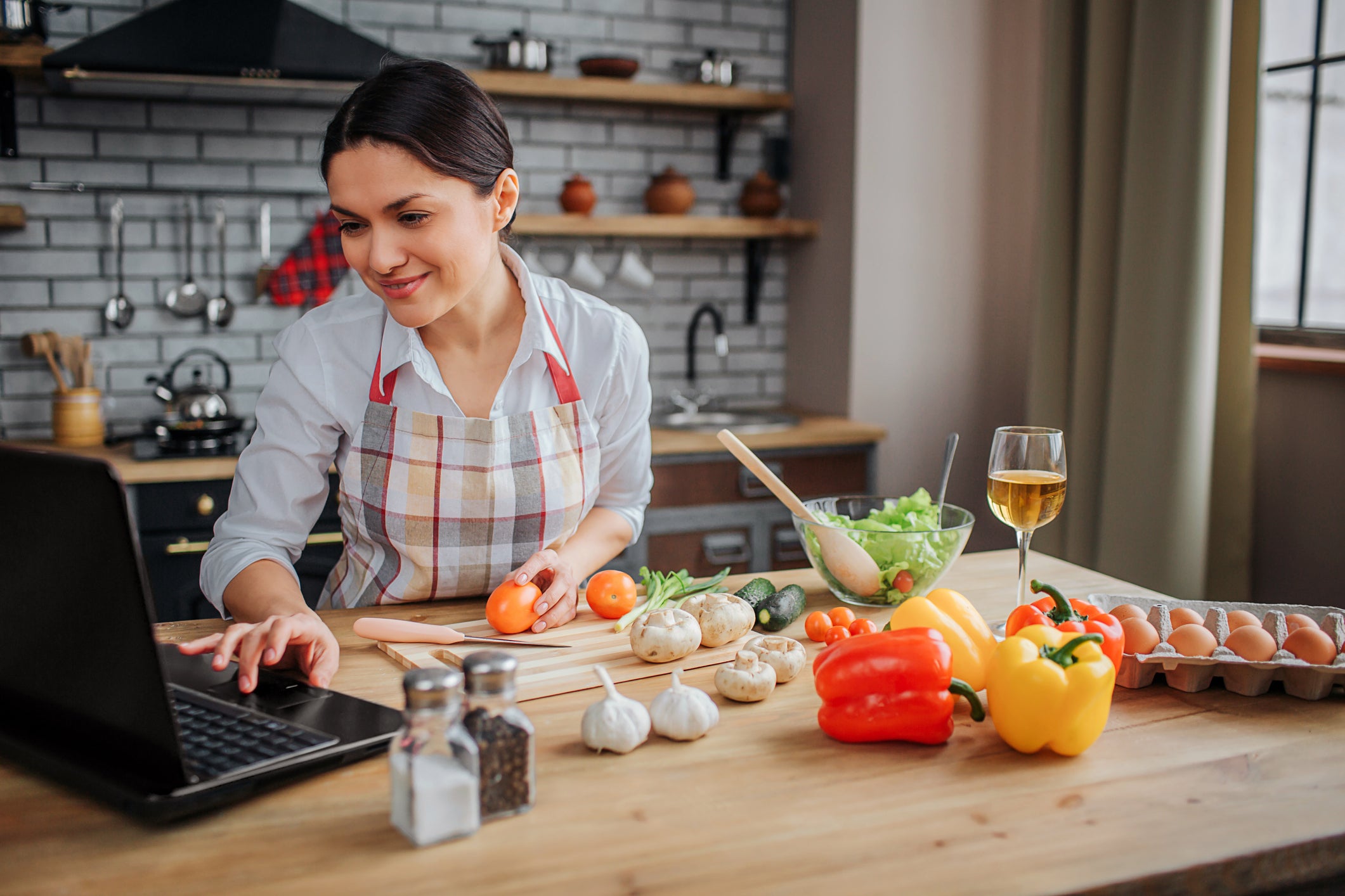 Person looking at computer while taking an online cooking class