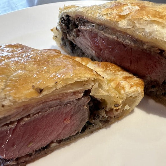 Plate of beef wellington cut in half