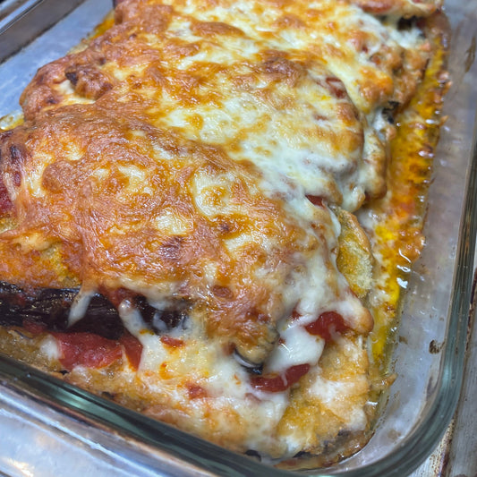 a baking dish with layers of eggplant, cheese and tomato sauce