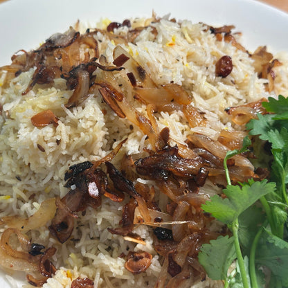 a plate of rice garnished with caramelized onions