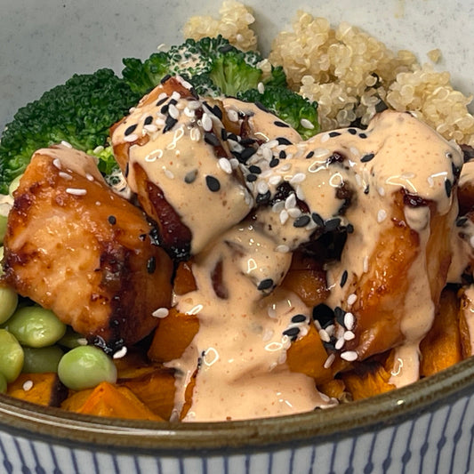 bowl of salmon, quinoa and spicy creamy sauce